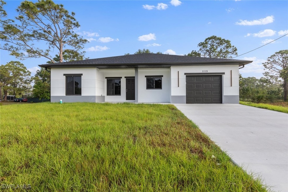 View of front of house with a garage, stucco sidin
