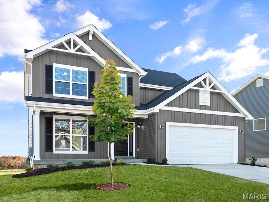 Craftsman-style house featuring a front lawn, driveway, an attached garage, and board and batten siding