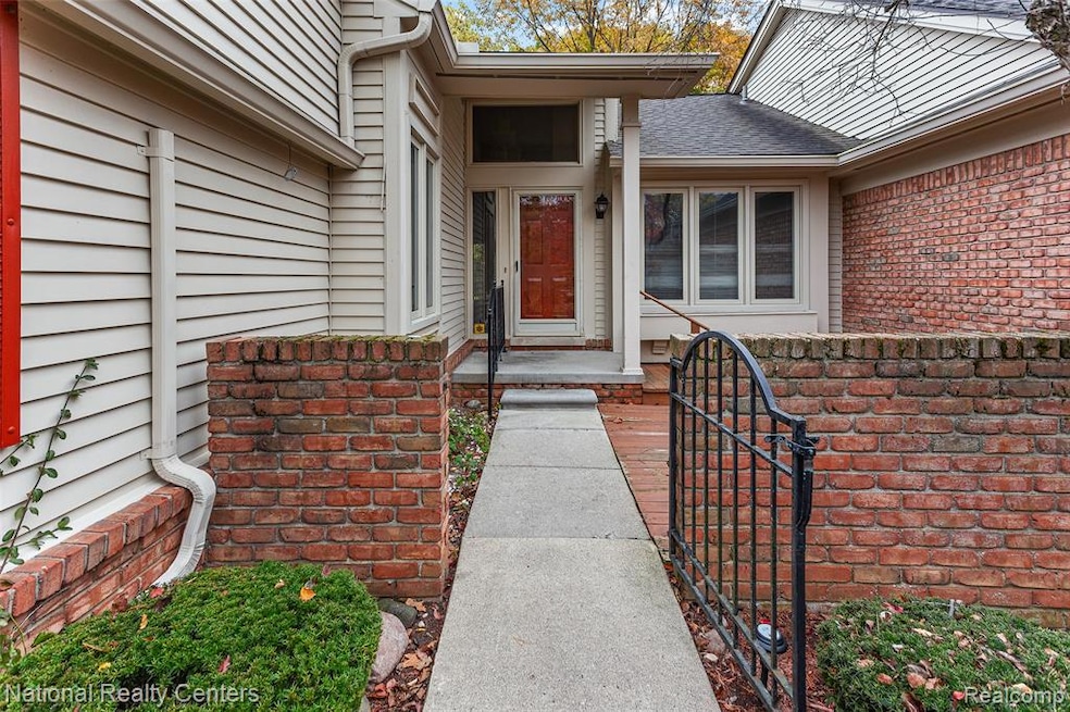 View of exterior entry with a shingled roof