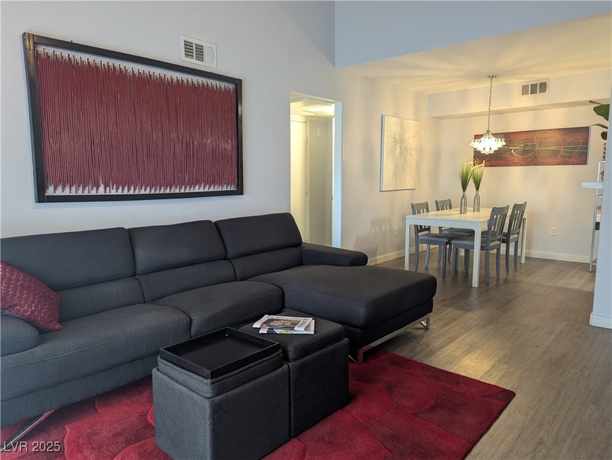 Living room with a chandelier, wood finished floor