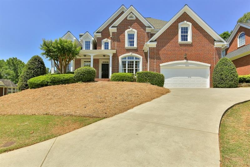 Large corner lot with home perched regally above t