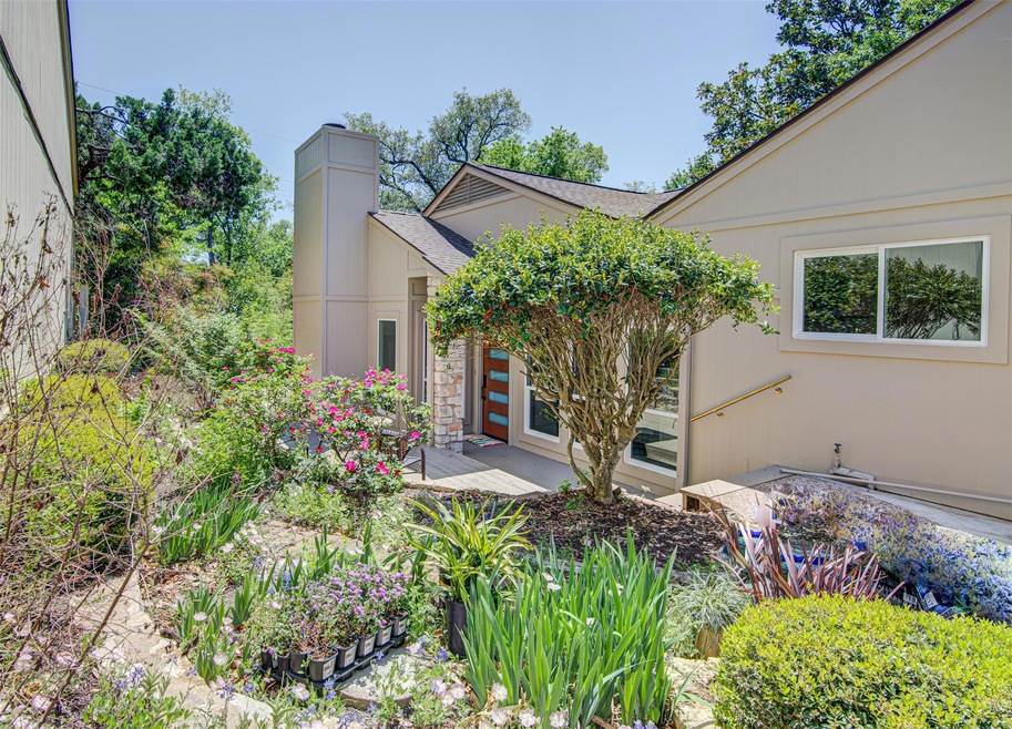 Doorway to property featuring roof with shingles 