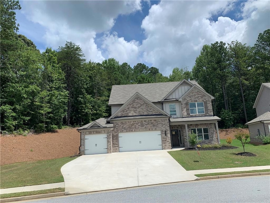 View of front of home featuring a garage and a front yard