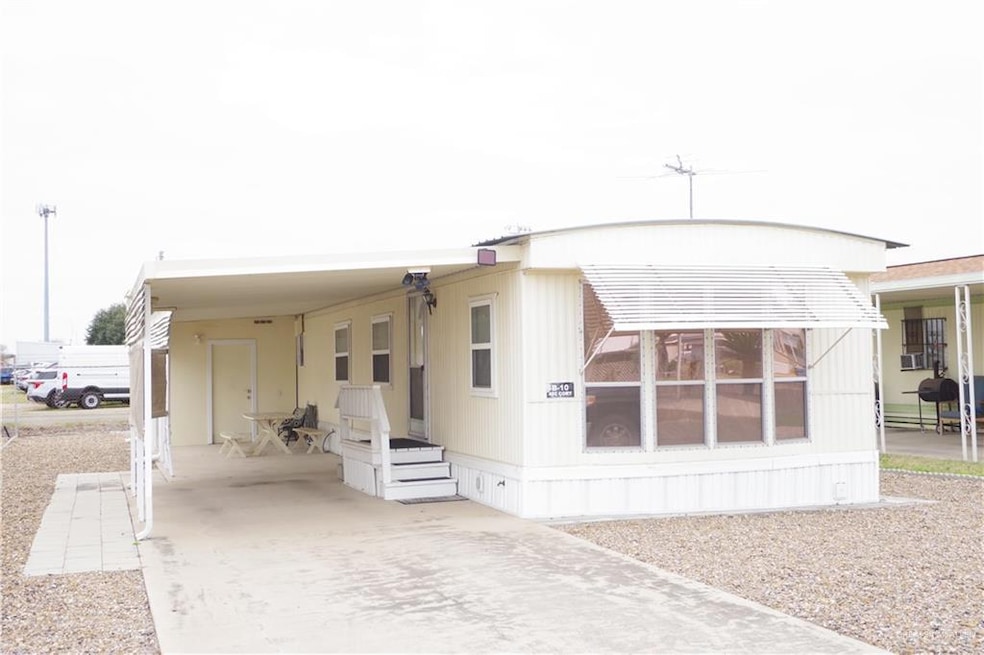 View of front of house with a carport and driveway