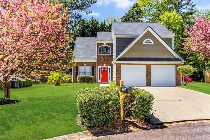 View of front of property featuring a garage and a