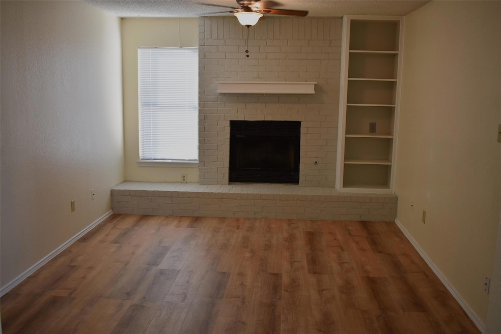 Unfurnished living room with a ceiling fan, wood 