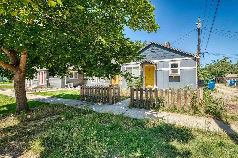 Bungalow-style home with a fenced front yard and a chimney
