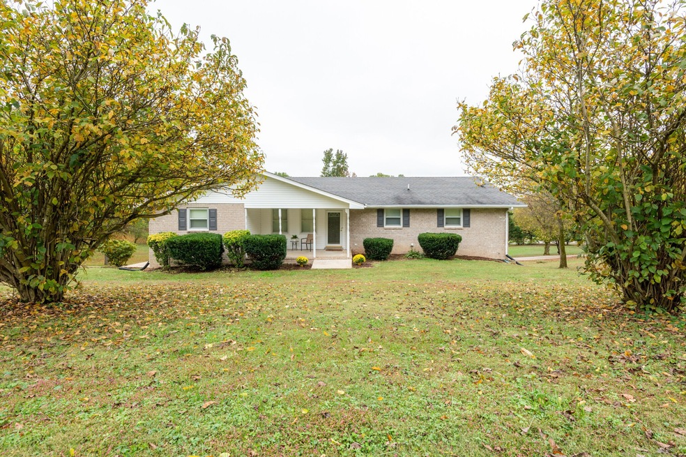 Amazing one story brick ranch with a 1 acre corner lot with beautiful trees!