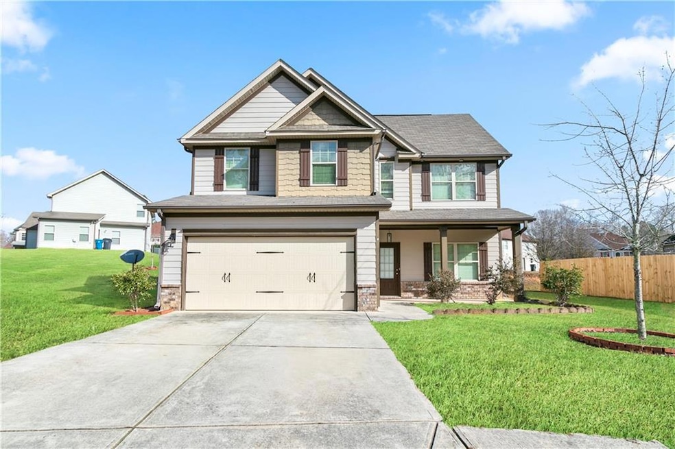Craftsman-style house with a garage and a front la