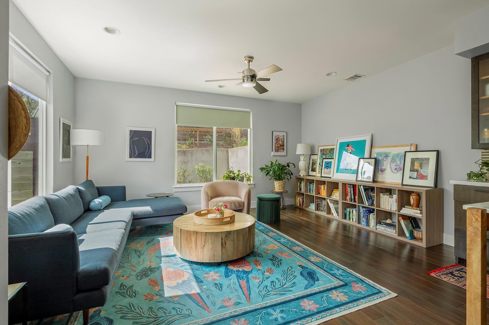 Living area with dark wood-style floors, a ceilin
