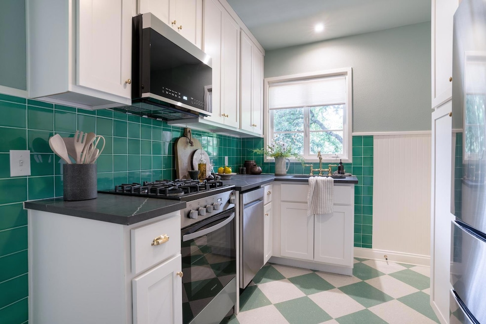 Kitchen featuring stainless steel appliances, lig