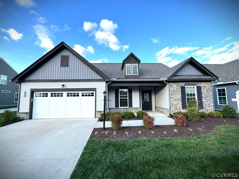 Craftsman inspired home featuring a garage and a f