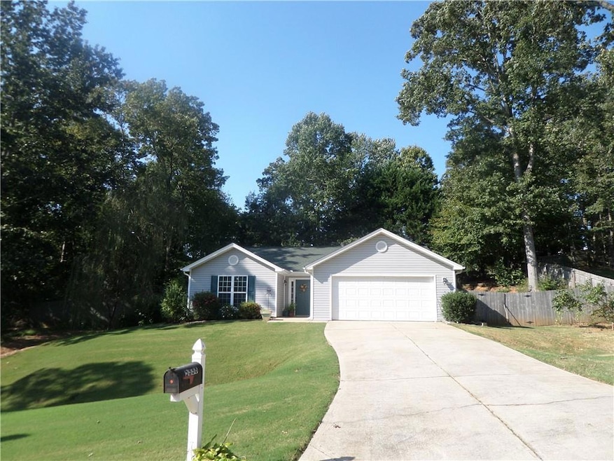 View of front of home with a front yard and a gara
