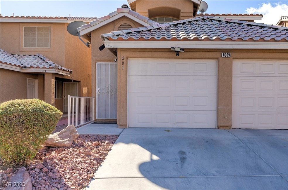 View of property featuring a tile roof, stucco sid