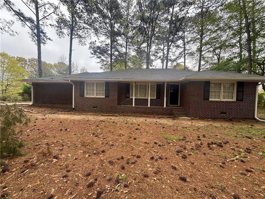 Ranch-style house featuring brick siding