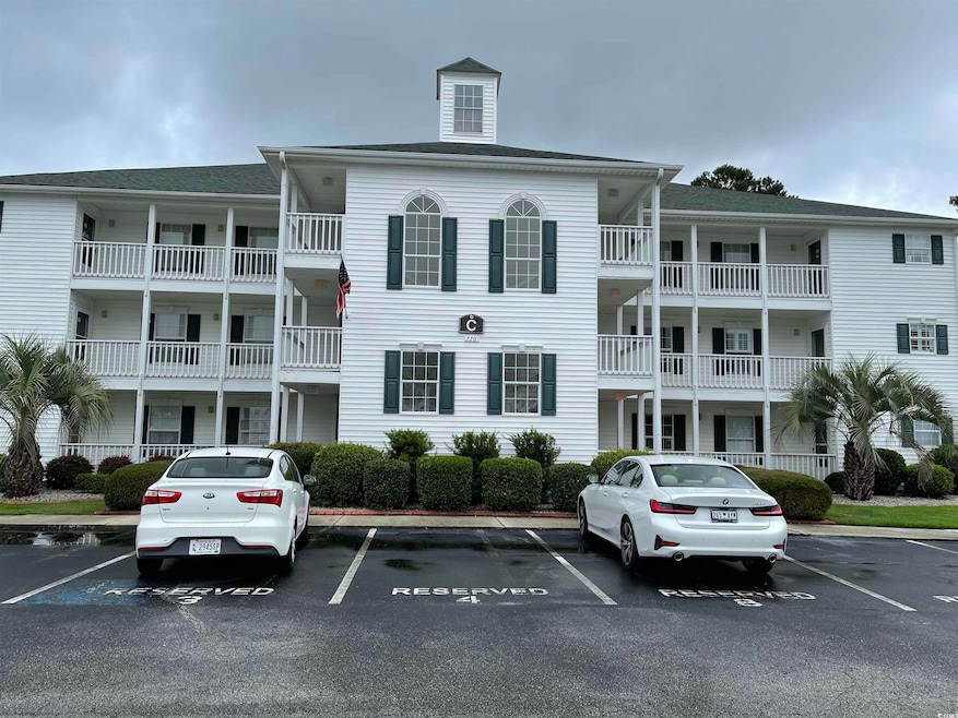 View of property with uncovered parking