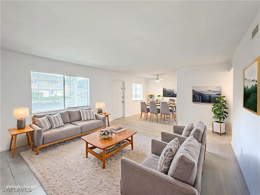 Living room with baseboards and a ceiling fan