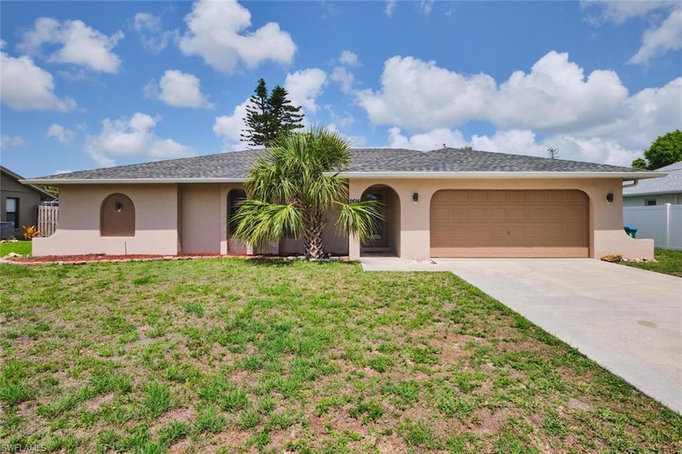 Single story home featuring stucco siding, driveway, and a garage