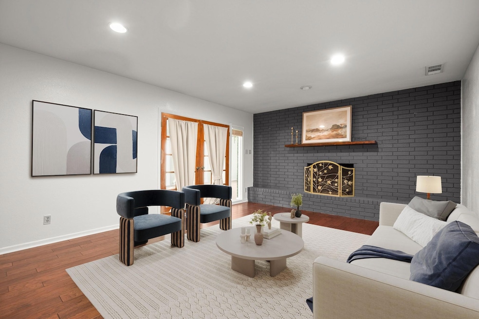 Living room with french doors, a fireplace, reces