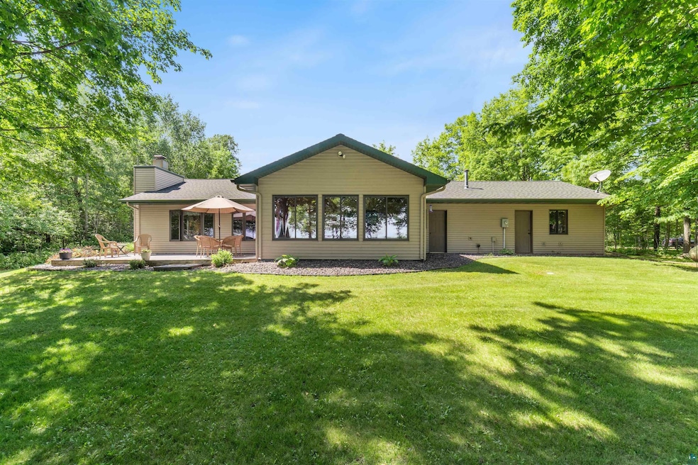 Rear view of property with a yard, a chimney, and a patio area