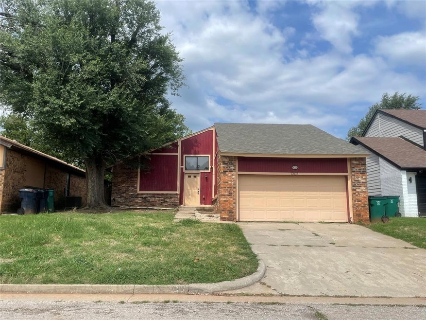 View of front facade with a garage and a front law