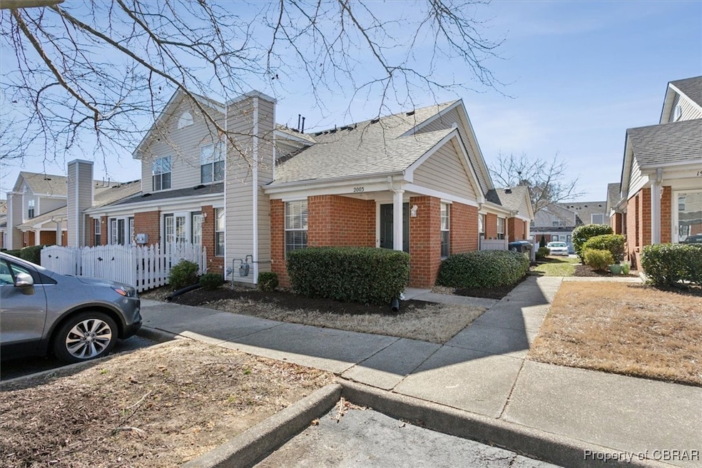 View of side of property featuring brick siding an