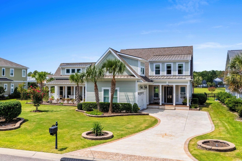 View of front of home with a garage and a front la
