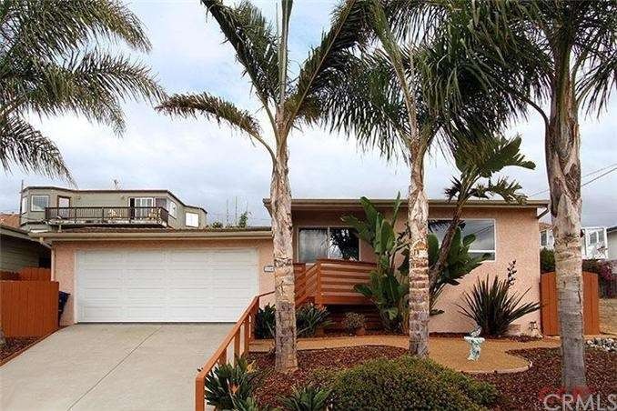 Front of home highlighting the palms and drought r