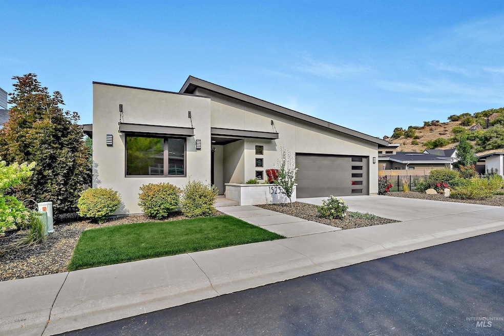 Contemporary house with stucco siding, concrete driveway, and an attached garage