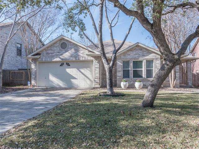 Lovely single story home with large trees and a pr