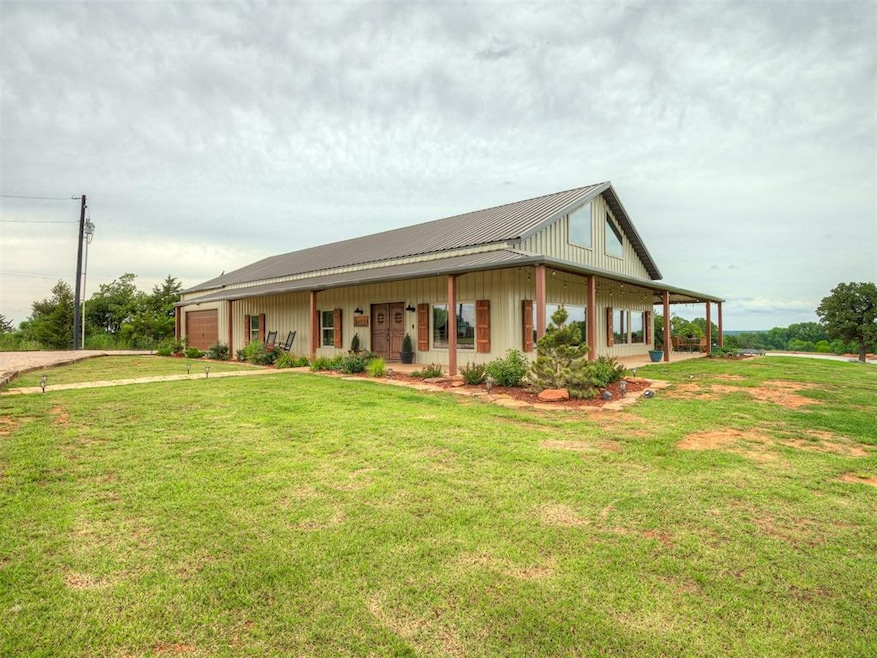 Farmhouse featuring a front yard, a metal roof, and board and batten siding