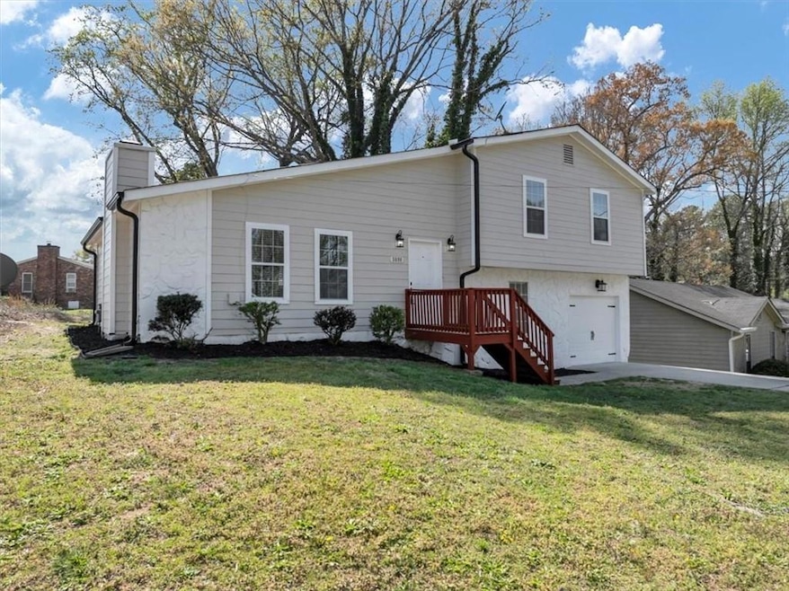 Back of property with a lawn and a chimney
