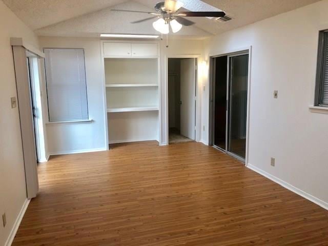 Unfurnished bedroom featuring two closets, wood f