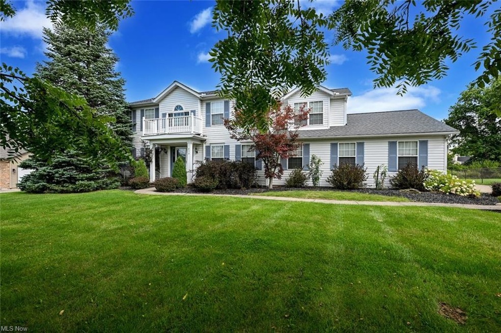 View of front of property with a front lawn and ba