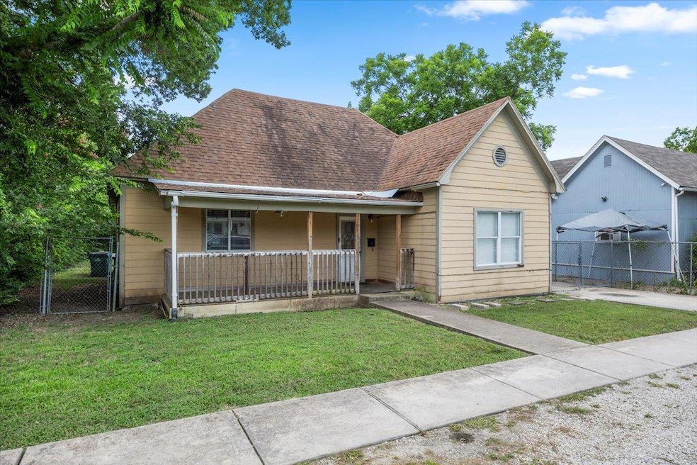 View of front facade with a gate, covered porch, 