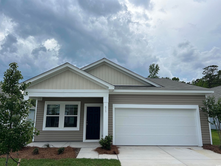 View of front of house featuring concrete driveway