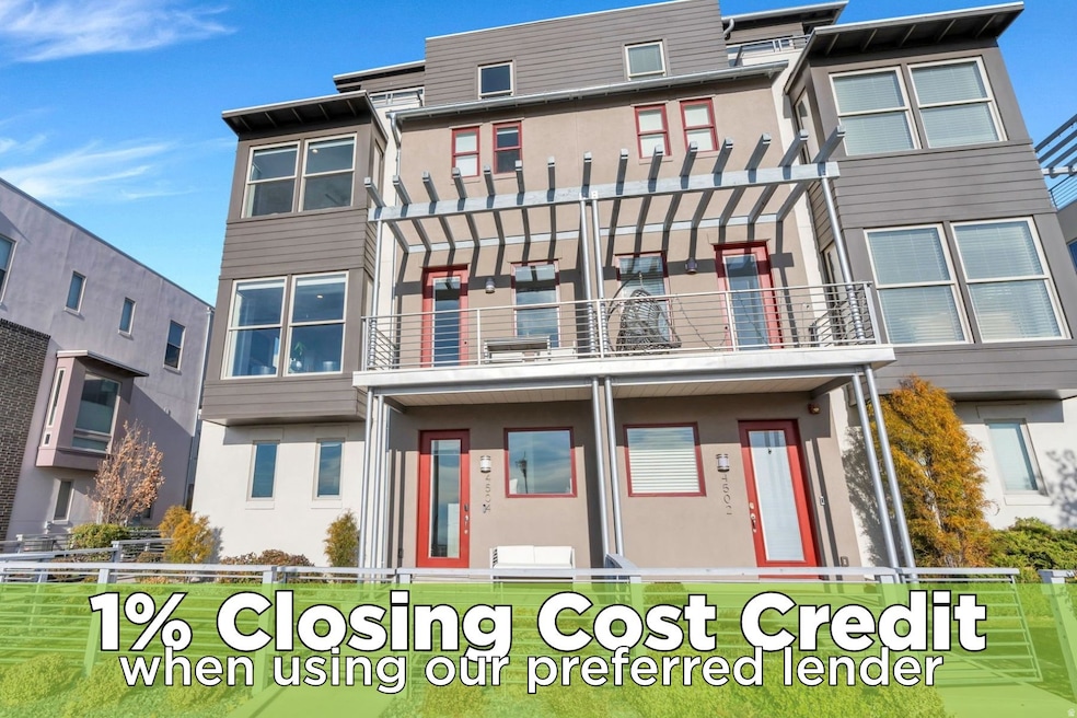 View of front of house with stucco siding and a balcony