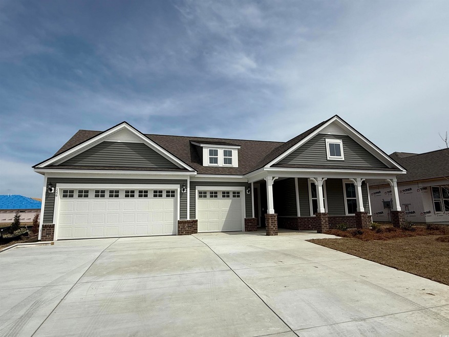 Craftsman-style home featuring concrete driveway, 