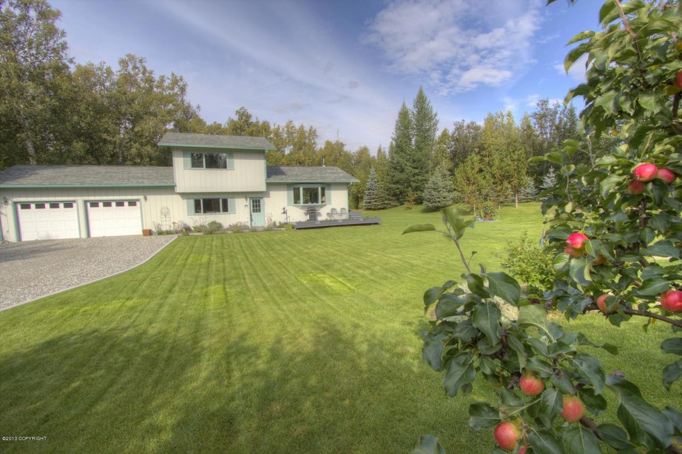 Front of home with loaded apple tree