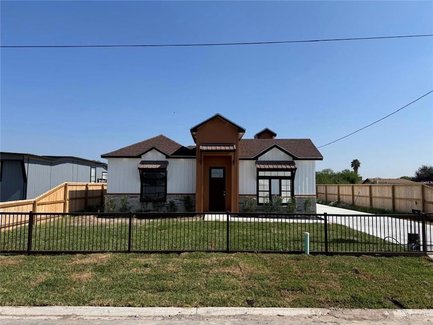 Modern farmhouse style home with a fenced front yard and stone siding
