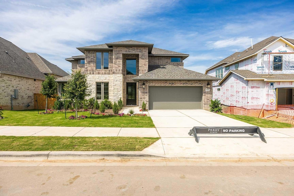 View of front of house with a garage, brick sidin