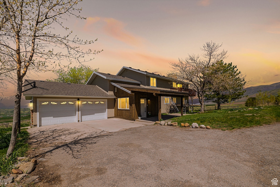 View of front of home featuring driveway, a shingled roof, a garage, board and batten siding, and a porch
