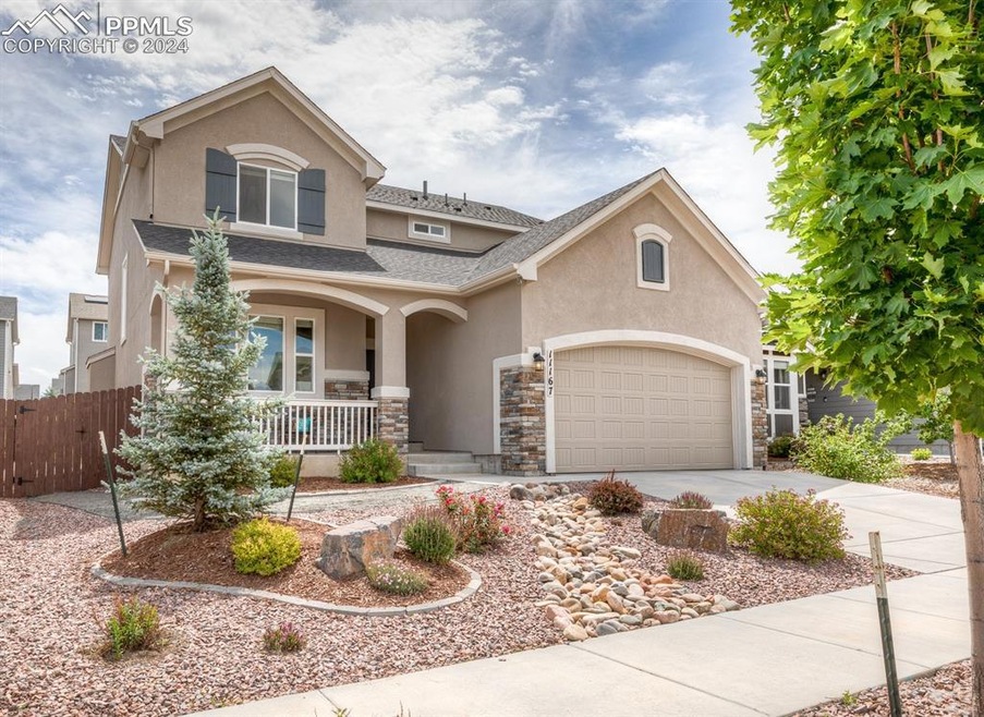 View of front of property featuring a garage and a