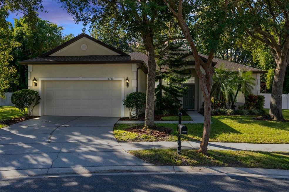 Beautiful tree lined landscaping surrounds this gr