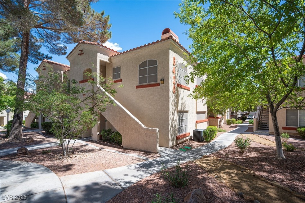 View of front of property with stairway, stucco siding, and a tiled roof