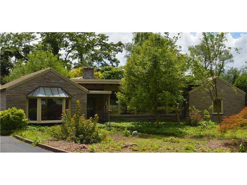 Exterior Front. Custom built mid century stone ran