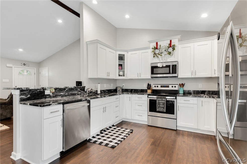 Kitchen featuring white cabinets, appliances with