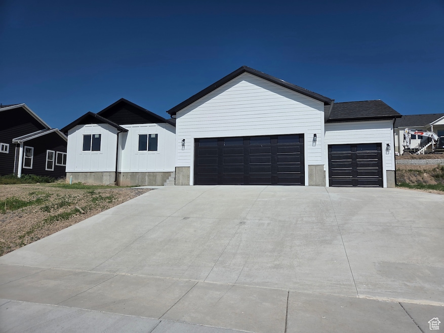 Modern farmhouse with an attached garage and driveway
