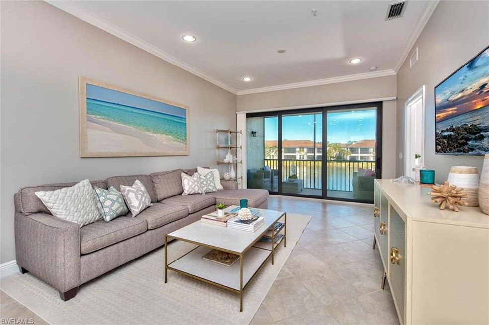 Great room with sliders to lanai & lake view. Feat