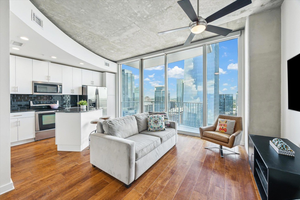 Living room featuring expansive windows, hardwood